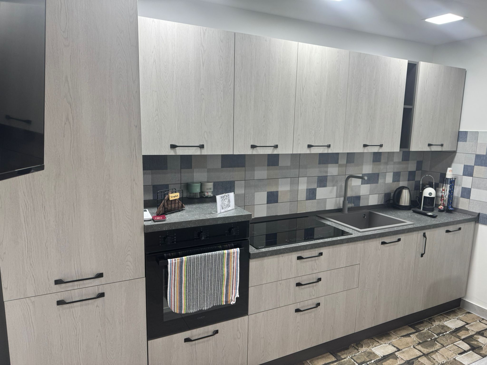Modern kitchen with induction hob and sink in the ALI APARTMENT vacation rental in Pizzo