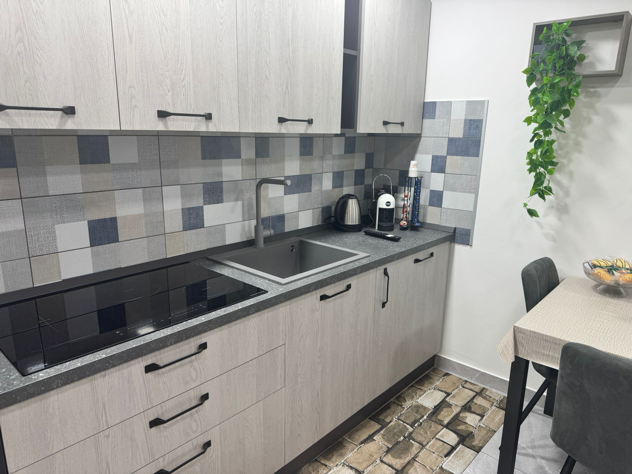 Full kitchen view with oven and cabinets in the ALI APARTMENT